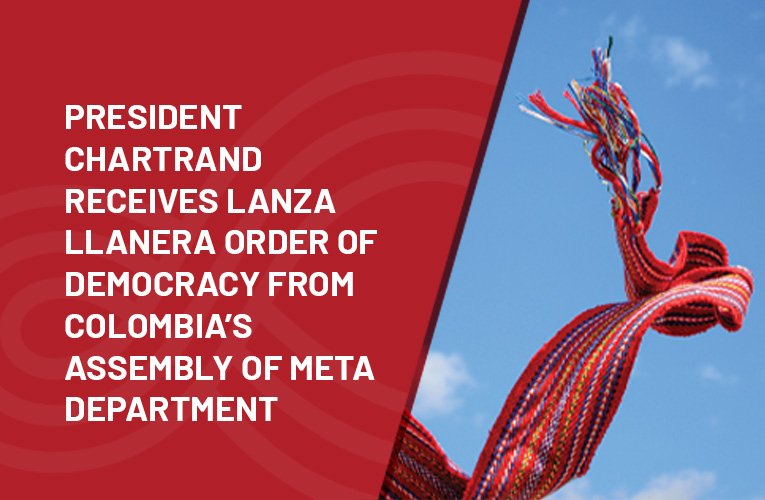 President Chartrand receives Lanza Llanera Order of Democracy from 